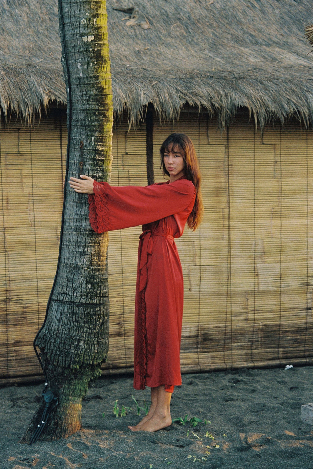eirene red satin robe, shown from the side
